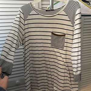 White 3/4 sleeve top with black stripes. Pocket on front with brown top.